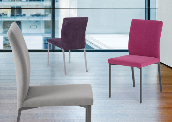 A tall slim modern dining chair that is made to order with