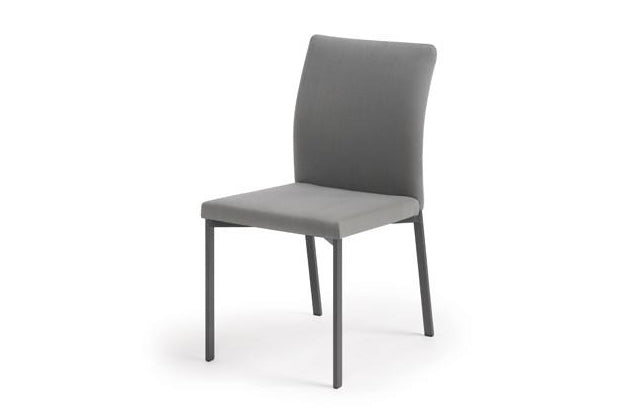 A tall slim modern dining chair that is made to order with