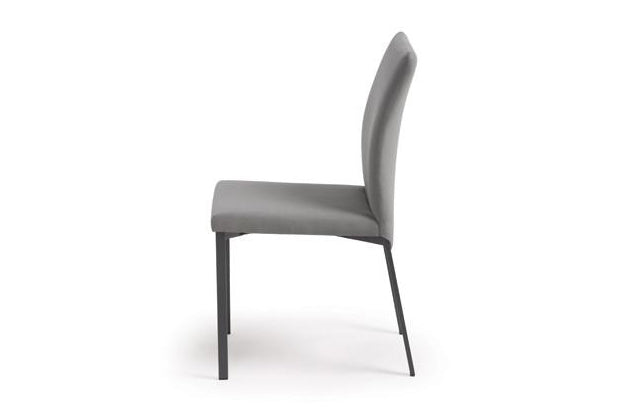 A tall slim modern dining chair that is made to order with