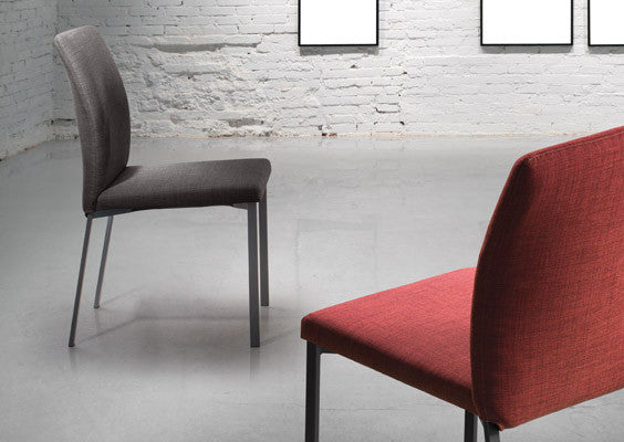 A tall slim modern dining chair that is made to order with